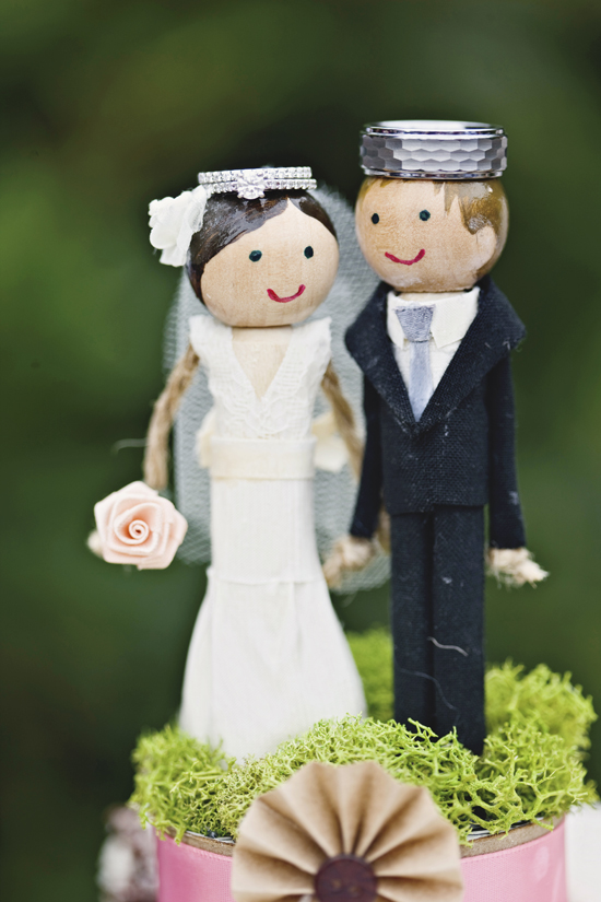 DIY cake topper made with doll pins, wooden beads, paint, and fabric scraps