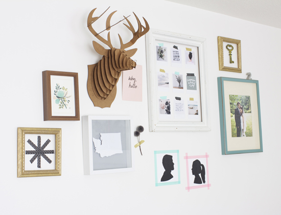 Gallery wall with cardboard deer head and DIY art