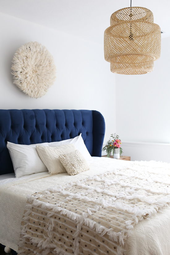 Guest bedroom - blue upholstered bed with neutral bedding and details